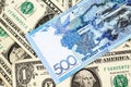 A blue tenge note from Kazakhstan with American one dollar bills