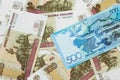 A blue tenge note from Kazakhstan with Russian one hundred ruble bills