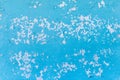 Blue flakes of old peeled dirty paint from the surface of the white concrete wall texture background Royalty Free Stock Photo