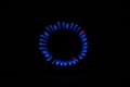 Blue flame of a burning burner in the dark background