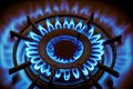 blue flame burning on burner of metal gas kitchen stove Royalty Free Stock Photo