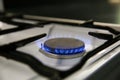 Blue flame of gas stove closeup side view