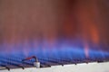 Blue flames of a gas burner inside of a boiler Royalty Free Stock Photo