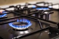 Blue flames on gas stove burner at home Royalty Free Stock Photo