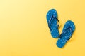 Blue flip flops on yelow Background. Top view with copy space Royalty Free Stock Photo