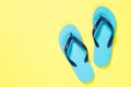 Blue flip flops on yelow. Royalty Free Stock Photo
