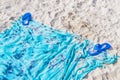 Blue flipflops on blue beach blanket towel on white sand Royalty Free Stock Photo