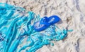 Blue flipflops on blue beach blanket towel on white sand Royalty Free Stock Photo