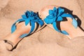 Blue flipflops on sand Royalty Free Stock Photo