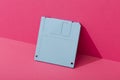 Blue floppy disk on a pink background Royalty Free Stock Photo