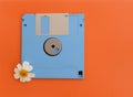 Blue floppy disk with white flower Royalty Free Stock Photo