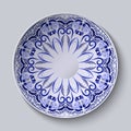 Blue floral pattern on a round plate. Stylization of Chinese porcelain painting.