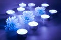 Blue flower and tea candles Royalty Free Stock Photo