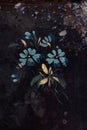 Blue flowers painted on black, ancient background