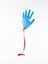 Blue flying inflated medical glove with red ribbon on white background. National doctors day concept