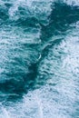 Blue foamy ocean waves and sand aerial drone view