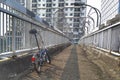 Blue folding bike parked on a pedestrian bridge