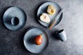 Blue food ceramic set with plates and pears over grey textured background