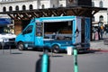 Blue food truck in a public environment in Osio