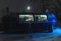 Blue food truck on a winter evening. Grain, noise