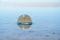 Blue freedom concept: The Crystal Ball reflecting water and sky in blue. Beautiful creative landscape photography