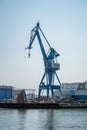 Blue freight cranes at Aarhus Harbor Port, view from the distance, clear sky, Denmark, vertical shot