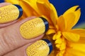 Blue French manicure with yellow craquelure nail Polish close-up