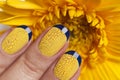 Blue French manicure with yellow craquelure nail Polish close-up Royalty Free Stock Photo