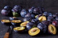 Blue fresh juicy plums on dark table Royalty Free Stock Photo