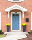 A blue front door detail of a red brick home. Royalty Free Stock Photo
