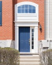 A blue front door on a red brick home. Royalty Free Stock Photo