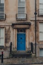 Blue front door on a traditional limestone house in Bath, UK