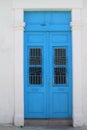Blue front door in white stone wall Royalty Free Stock Photo