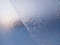 Blue Frost Background, Closeup Frozen Winter Window Pane Coated Shiny Icy Frost Patterns. Natural Ice Pattern on a