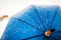 Blue frozen umbrella on the snowy storm outdoors