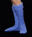 Blue gaiters from wool on female feet Royalty Free Stock Photo