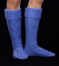 Blue gaiters from wool on female feet Royalty Free Stock Photo
