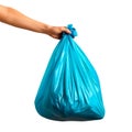 A blue garbage bag in a hand, isolated against a white or transparent background. Close-up of the blue garbage bag in a Royalty Free Stock Photo