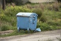 Blue garbage bin and uncollected Waste.