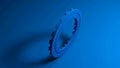 Blue front - toothed wheel rotates on a blue background - 3D rendering video clip