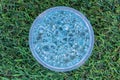 Blue gel balls in the middle on green artificial grass background