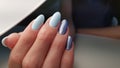 Blue gel polish nails with glitter for winter, spring or summer