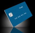 A blue generic credit card is seen reflected in a polished surface