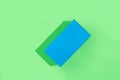 Blue geometric figure, a rectangular with shadows on a light green background.