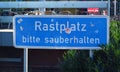 Blue German motorway station sign saying `resting place, please keep clean`