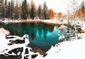 Blue geyser lake in autumn forest after snowfall. Altai, Russia Royalty Free Stock Photo