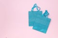 Blue gift bags on a light pink background Royalty Free Stock Photo