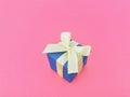 Blue gift box on bubblegum pink background. Royalty Free Stock Photo