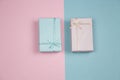 Blue gift box on a pink background and pink gift box on a blue background creative festive flat lay