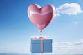 Blue gift box with pink ribbon bow and pink heart shaped balloon flying in the air on blue sky, Valentine s day background. Royalty Free Stock Photo